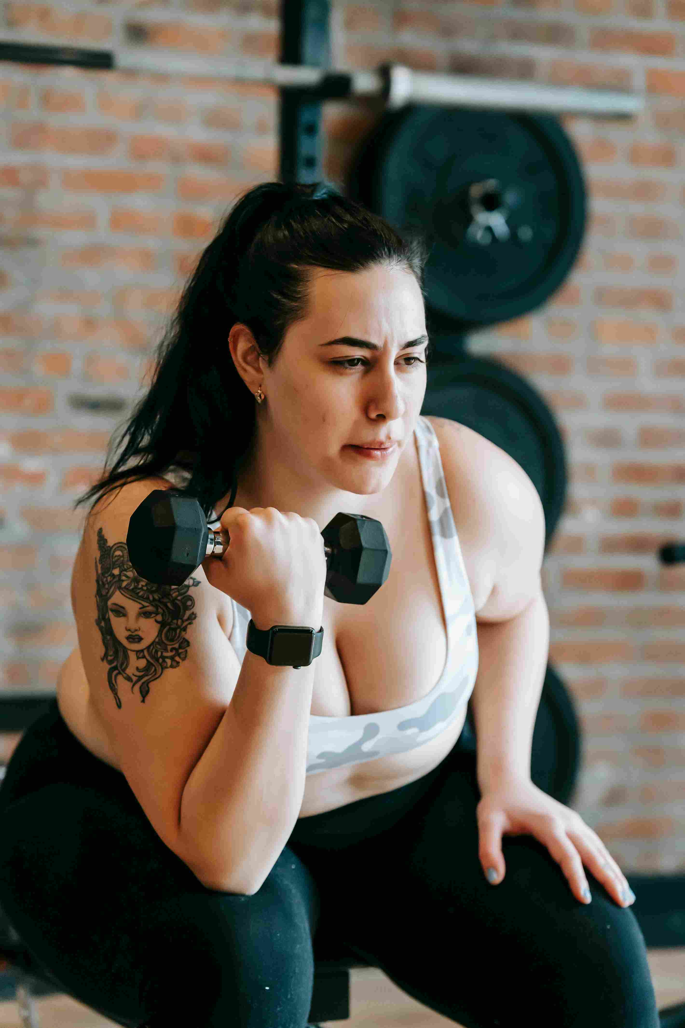 Person holding dumbbells at home